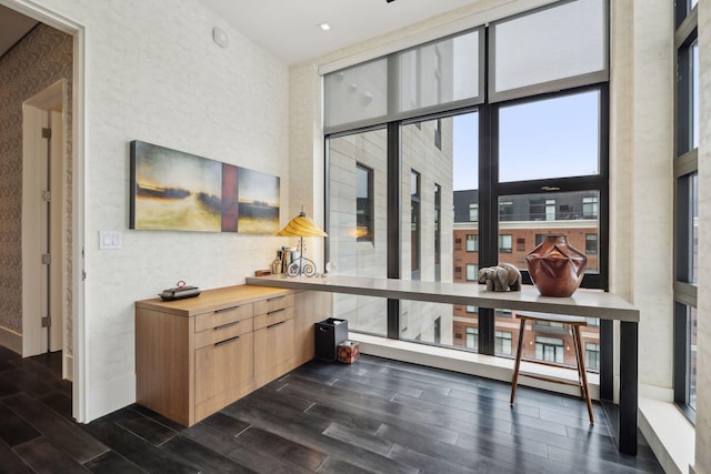 bar featuring floor to ceiling windows and light brown cabinetry