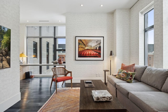 living room with expansive windows, dark hardwood / wood-style flooring, and a high ceiling