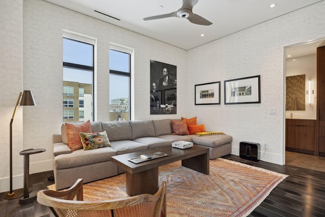 living room featuring ceiling fan and dark hardwood / wood-style floors