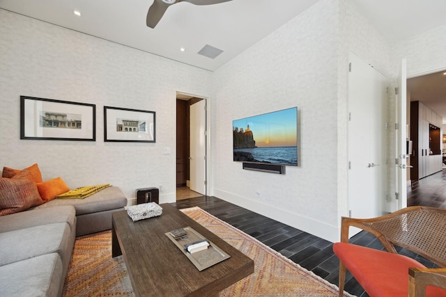 living room with dark hardwood / wood-style flooring and ceiling fan