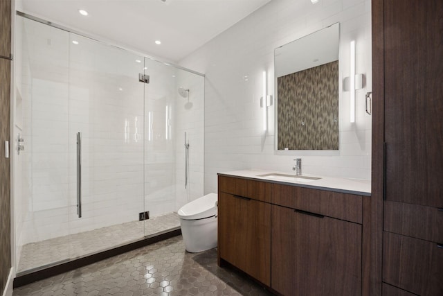 bathroom with tile patterned floors, toilet, a shower with shower door, tile walls, and vanity