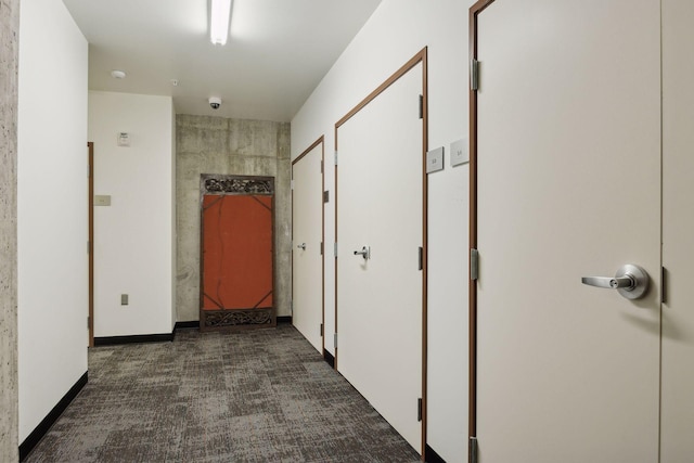 corridor featuring dark colored carpet