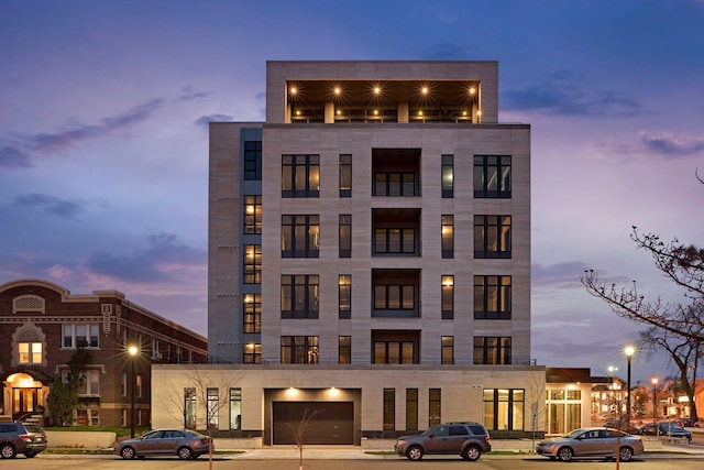 outdoor building at dusk featuring a garage