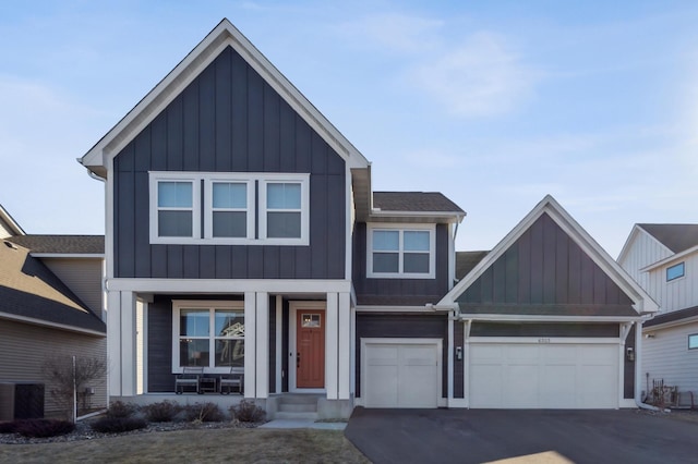 view of front of home with central AC, a porch, board and batten siding, and aphalt driveway