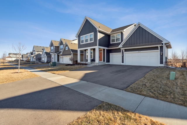 view of front of home with a residential view, aphalt driveway, and board and batten siding