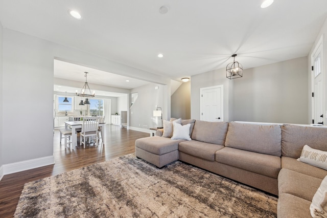 living room with dark wood finished floors, a notable chandelier, baseboards, and recessed lighting