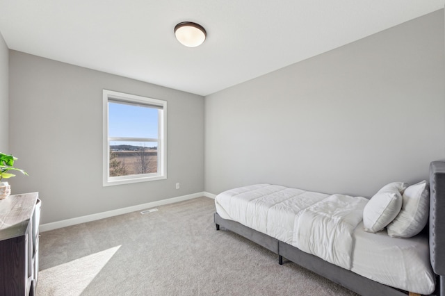 bedroom featuring carpet floors and baseboards