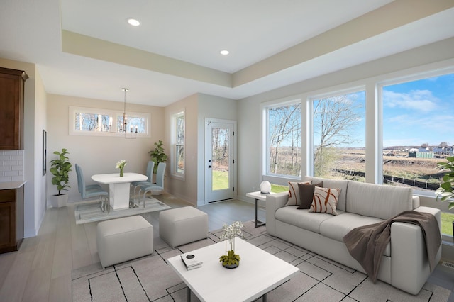 13104 Ghia Ct NE, Blaine, MN 55449 - living area with plenty of natural light, a chandelier, light wood-type flooring, recessed lighting, and baseboards