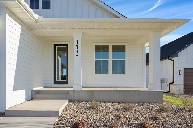 13104 Ghia Ct NE, Blaine, MN 55449 - entrance to property with covered porch and board and batten siding