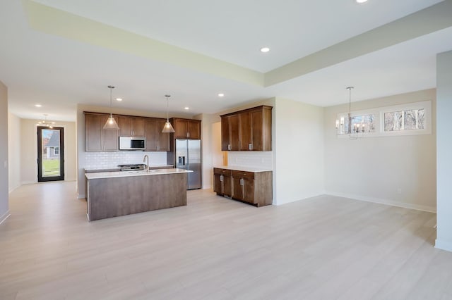 13104 Ghia Ct NE, Blaine, MN 55449 - kitchen with stainless steel fridge with ice dispenser, tasteful backsplash, a chandelier, light countertops, and recessed lighting