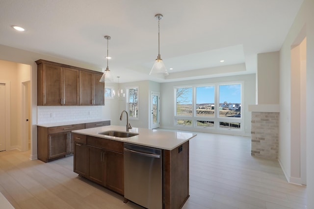 13104 Ghia Ct NE, Blaine, MN 55449 - kitchen with dishwasher, a sink, light countertops, decorative backsplash, and light wood-style floors