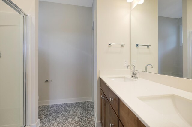 13104 Ghia Ct NE, Blaine, MN 55449 - full bath featuring baseboards, double vanity, a shower with door, and tile patterned floors