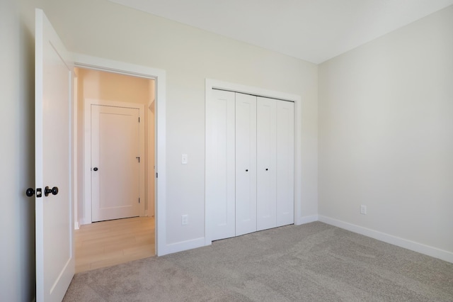 13104 Ghia Ct NE, Blaine, MN 55449 - unfurnished bedroom featuring carpet, baseboards, and a closet