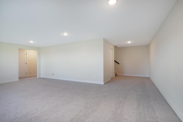 13104 Ghia Ct NE, Blaine, MN 55449 - spare room featuring recessed lighting, light carpet, stairs, and baseboards