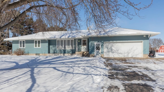 ranch-style house featuring driveway and a garage