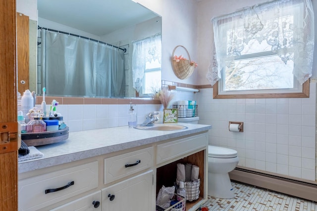 full bath with tile patterned flooring, a baseboard radiator, tile walls, toilet, and vanity