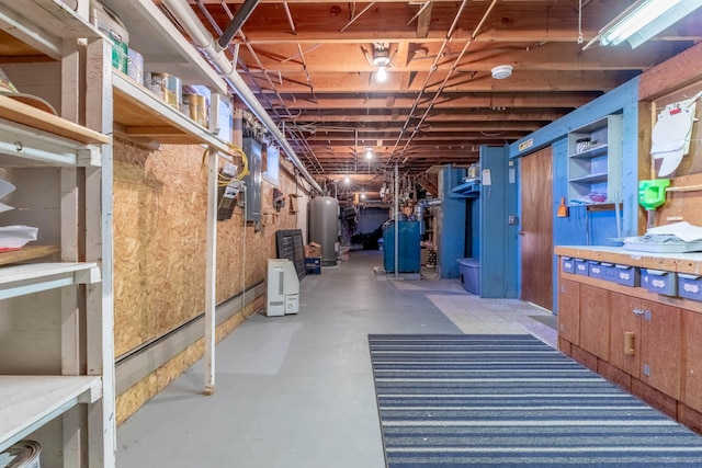 unfinished basement with water heater and a heating unit
