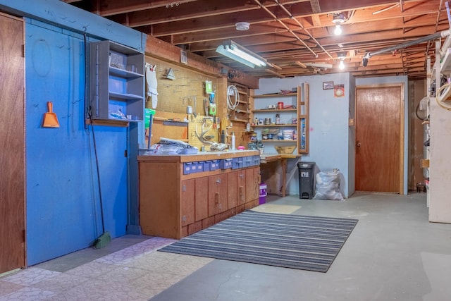 unfinished basement featuring a workshop area