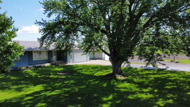 13959 55th St NE, Foley, MN 56329 - view of front of house with concrete driveway, a garage, and a front yard