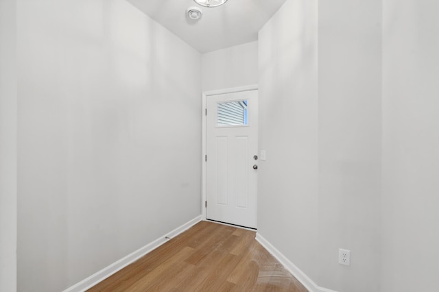 entryway featuring baseboards and light wood-style floors