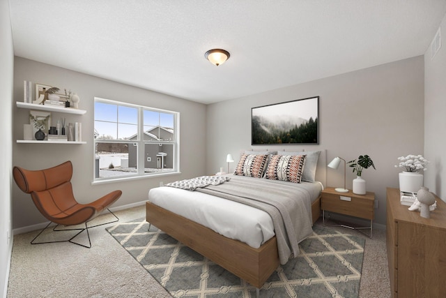 carpeted bedroom featuring baseboards