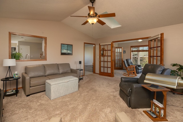 living room featuring ceiling fan, light colored carpet, lofted ceiling, and french doors