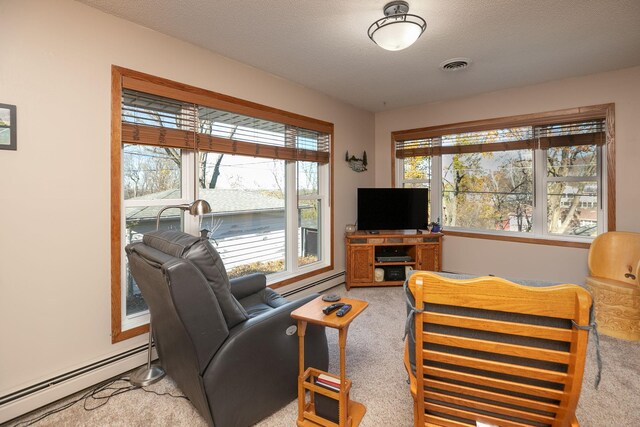 carpeted living room featuring a textured ceiling and a baseboard heating unit