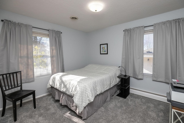 bedroom with a baseboard radiator, multiple windows, a textured ceiling, and dark colored carpet