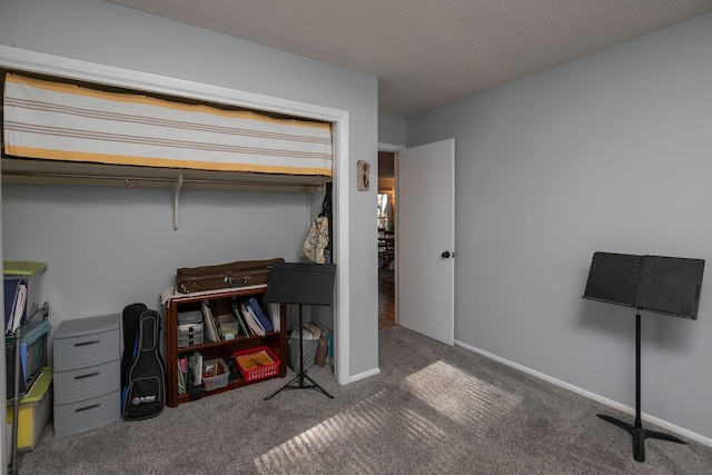 carpeted office with a textured ceiling