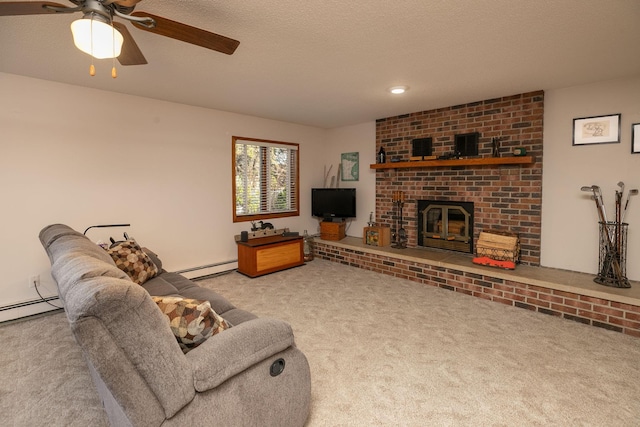 carpeted living room with a brick fireplace, a textured ceiling, a baseboard heating unit, and ceiling fan