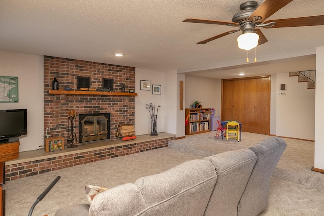 carpeted living room with a brick fireplace, a textured ceiling, and ceiling fan