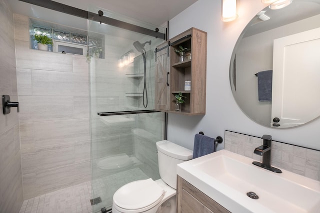 bathroom featuring toilet, an enclosed shower, and vanity