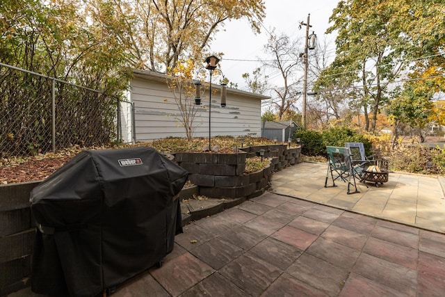 view of patio with a fire pit and area for grilling