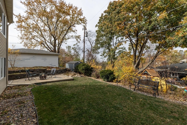 view of yard with a fire pit, a patio area, and a shed