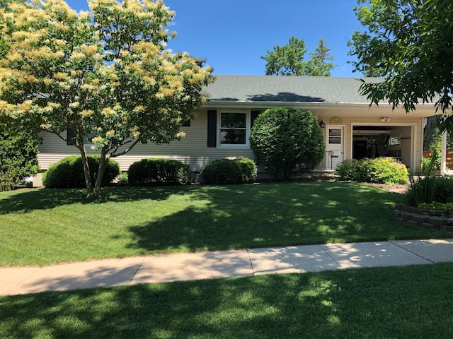 view of front of property with a garage and a front lawn