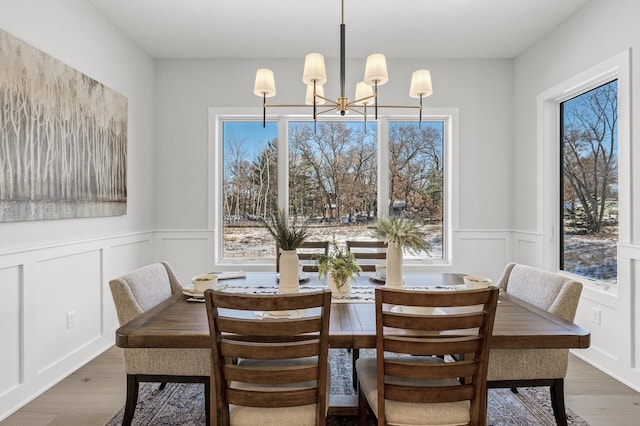 dining room with dark hardwood / wood-style flooring and an inviting chandelier