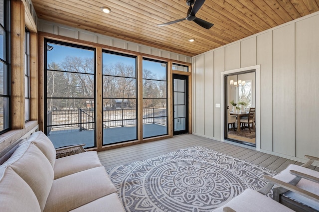 interior space featuring light hardwood / wood-style floors, wooden ceiling, and ceiling fan with notable chandelier