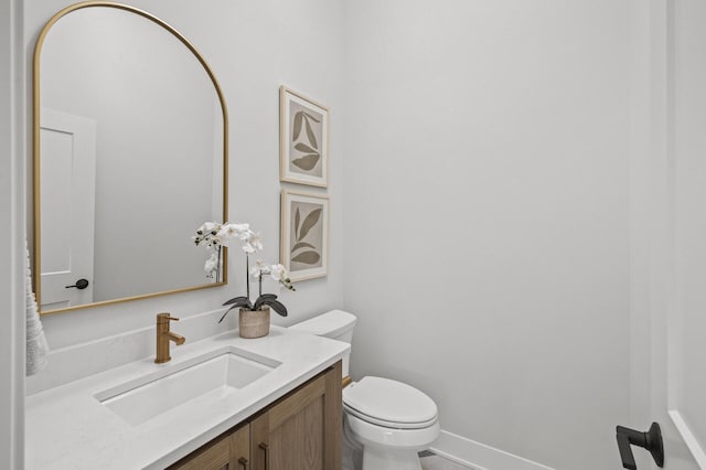 bathroom featuring toilet and vanity