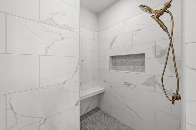 bathroom with a tile shower