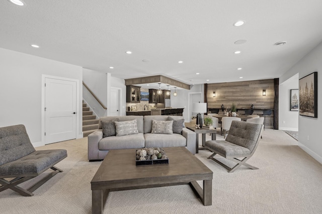 carpeted living room featuring bar area and wooden walls