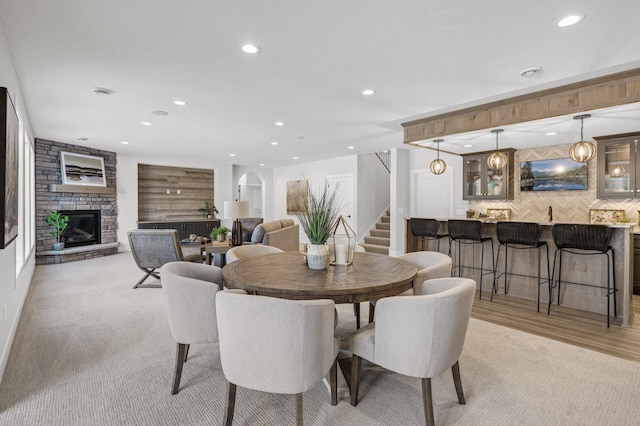 dining area featuring a fireplace and bar area