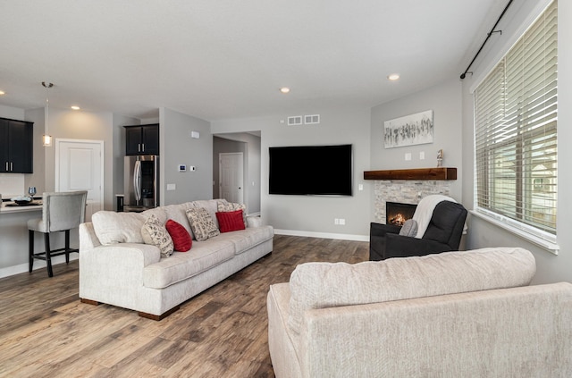 living room featuring a fireplace and dark hardwood / wood-style flooring