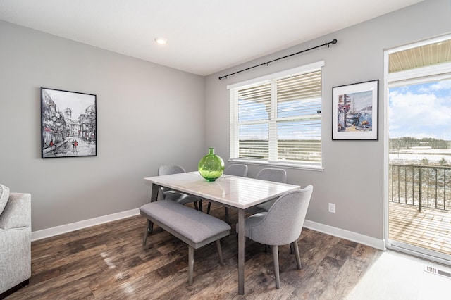 dining space with dark hardwood / wood-style flooring