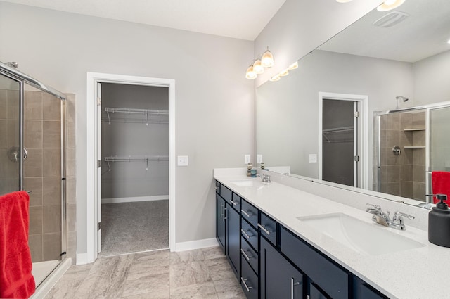 bathroom featuring tile patterned floors, an enclosed shower, and vanity