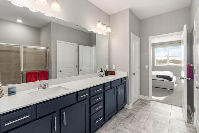 bathroom featuring vanity and a shower with door