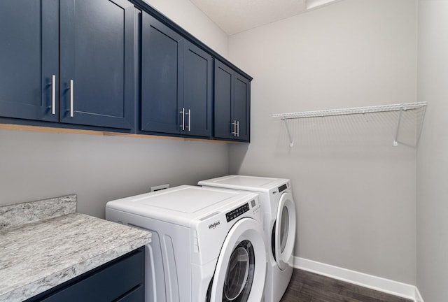 clothes washing area featuring dark wood-type flooring, cabinets, and independent washer and dryer