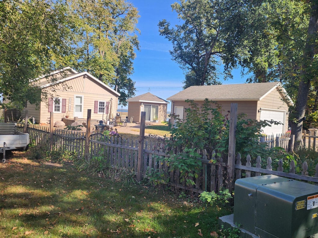 view of yard featuring an outbuilding and a garage