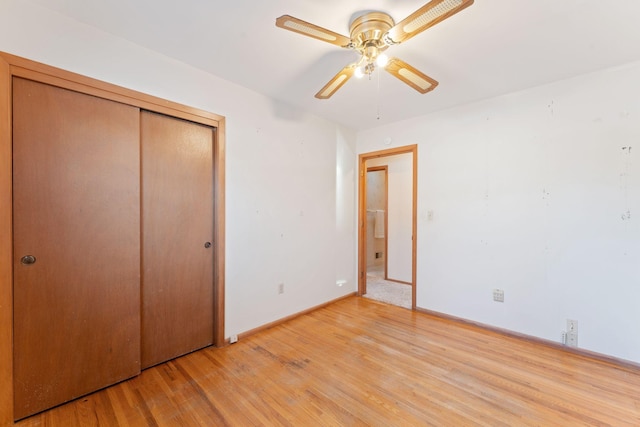 unfurnished bedroom featuring ceiling fan, a closet, and light hardwood / wood-style flooring