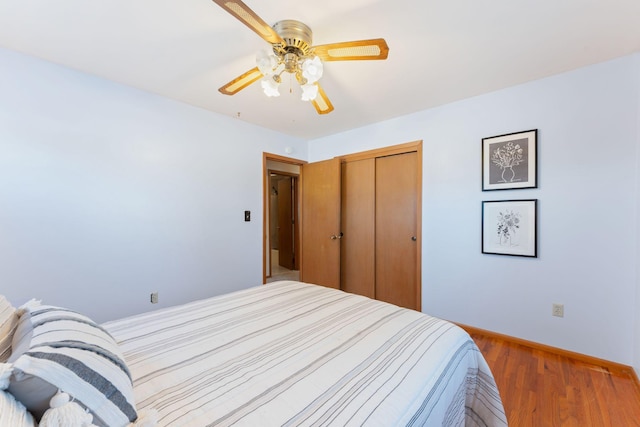 bedroom featuring hardwood / wood-style floors, a closet, and ceiling fan