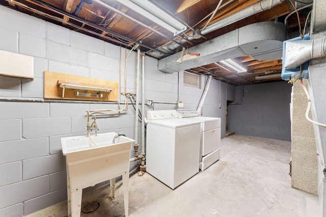 basement featuring separate washer and dryer and sink